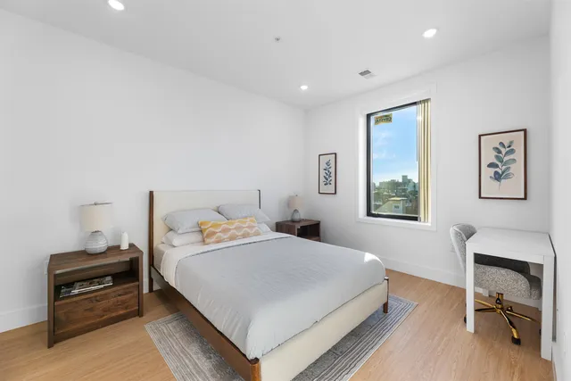 a bedroom with a bed and a desk