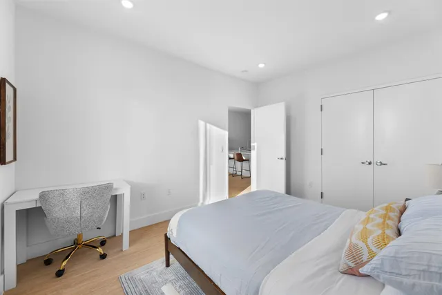 a bedroom with a bed and a chair