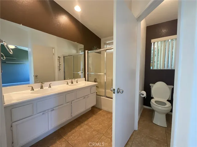 a bathroom with a tub sink toilet and mirror