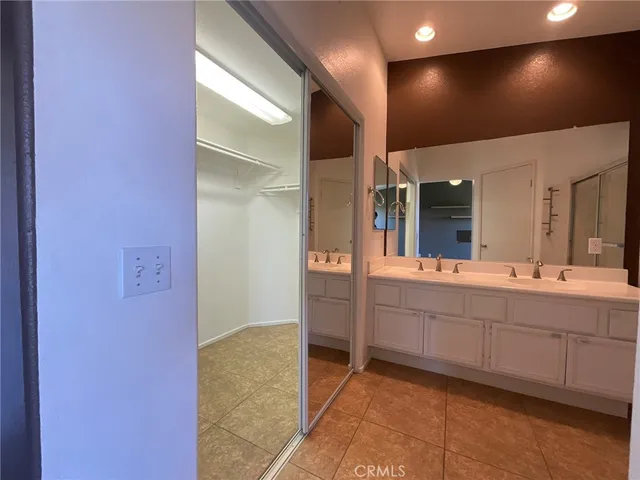 a spacious bathroom with a mirror and a sink