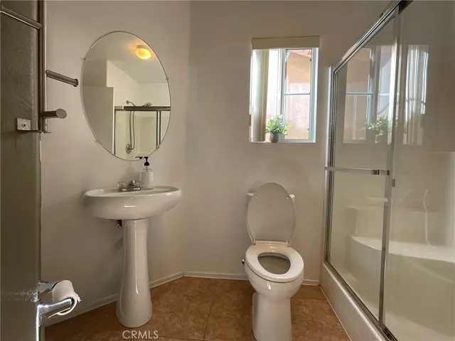 a bathroom with a toilet sink and shower