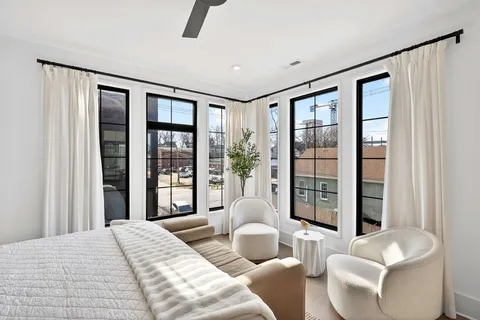 a bedroom with a large bed and a large window