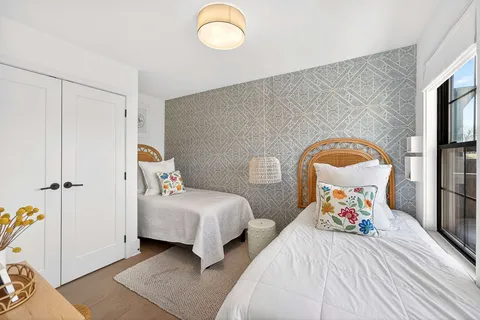 a living room with furniture a flat screen tv and a large window