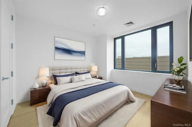 a bedroom with a large bed and a flat screen tv