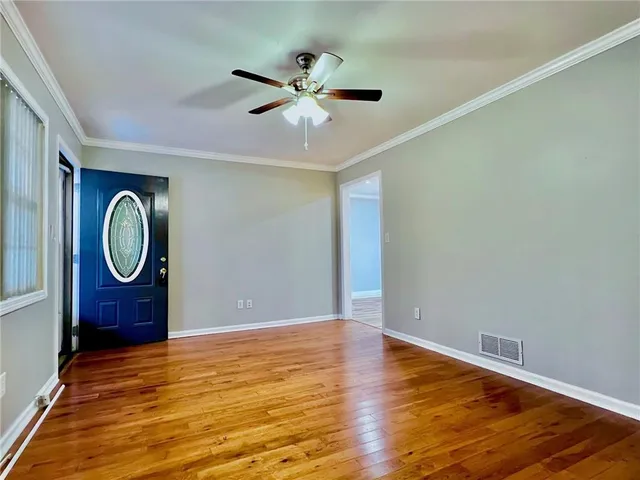 a view of a room with wooden floor and bathroom
