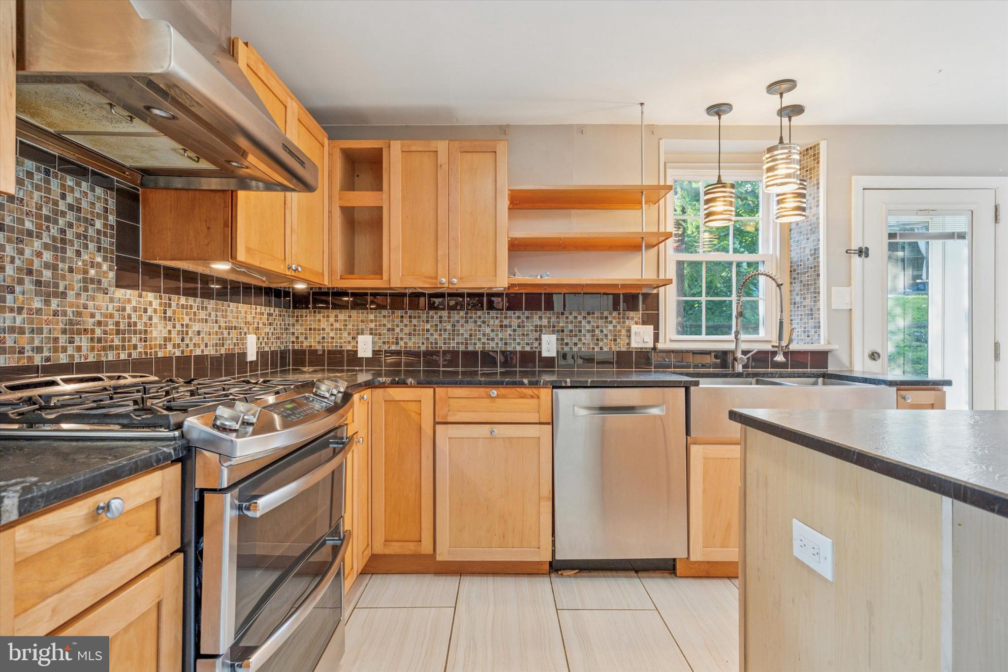 504 Plymouth Road Glenside, PA 19038 - Photo 13 of 28 a kitchen with stainless steel appliances granite countertop a sink stove and cabinets