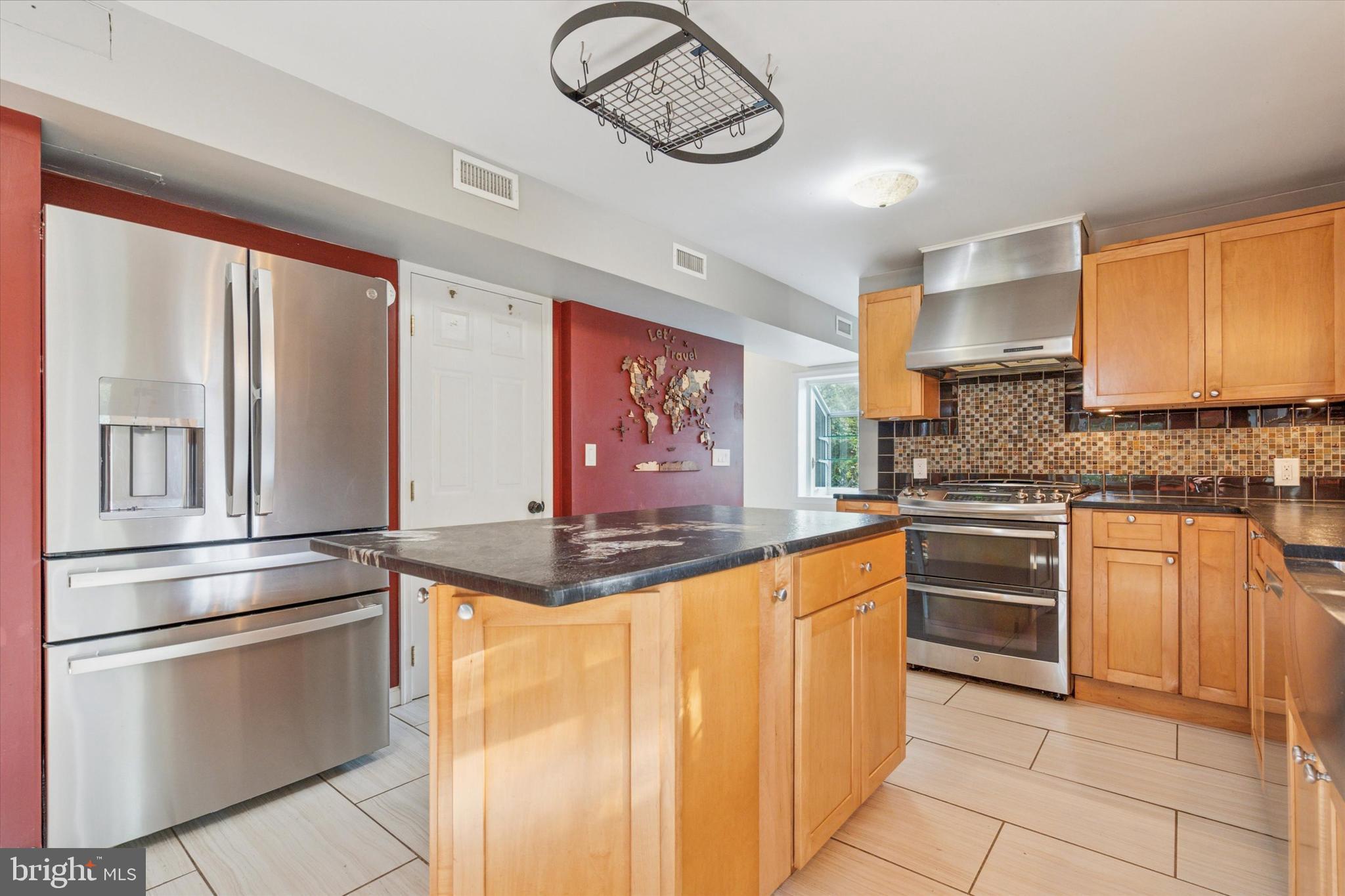 504 Plymouth Road Glenside, PA 19038 - Photo 14 of 28 a kitchen with stainless steel appliances granite countertop a stove and cabinets