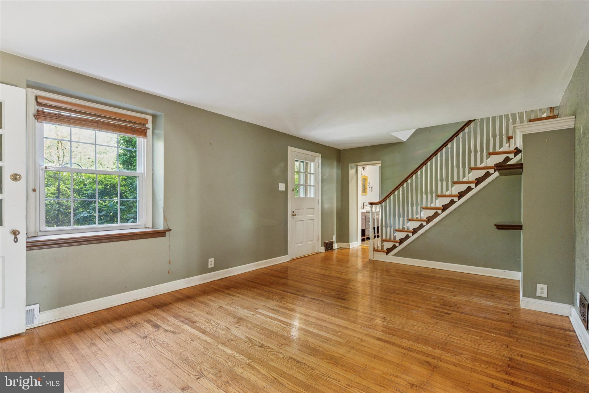 504 Plymouth Road Glenside, PA 19038 - Photo 2 of 28 a view of an empty room with wooden floor and a window