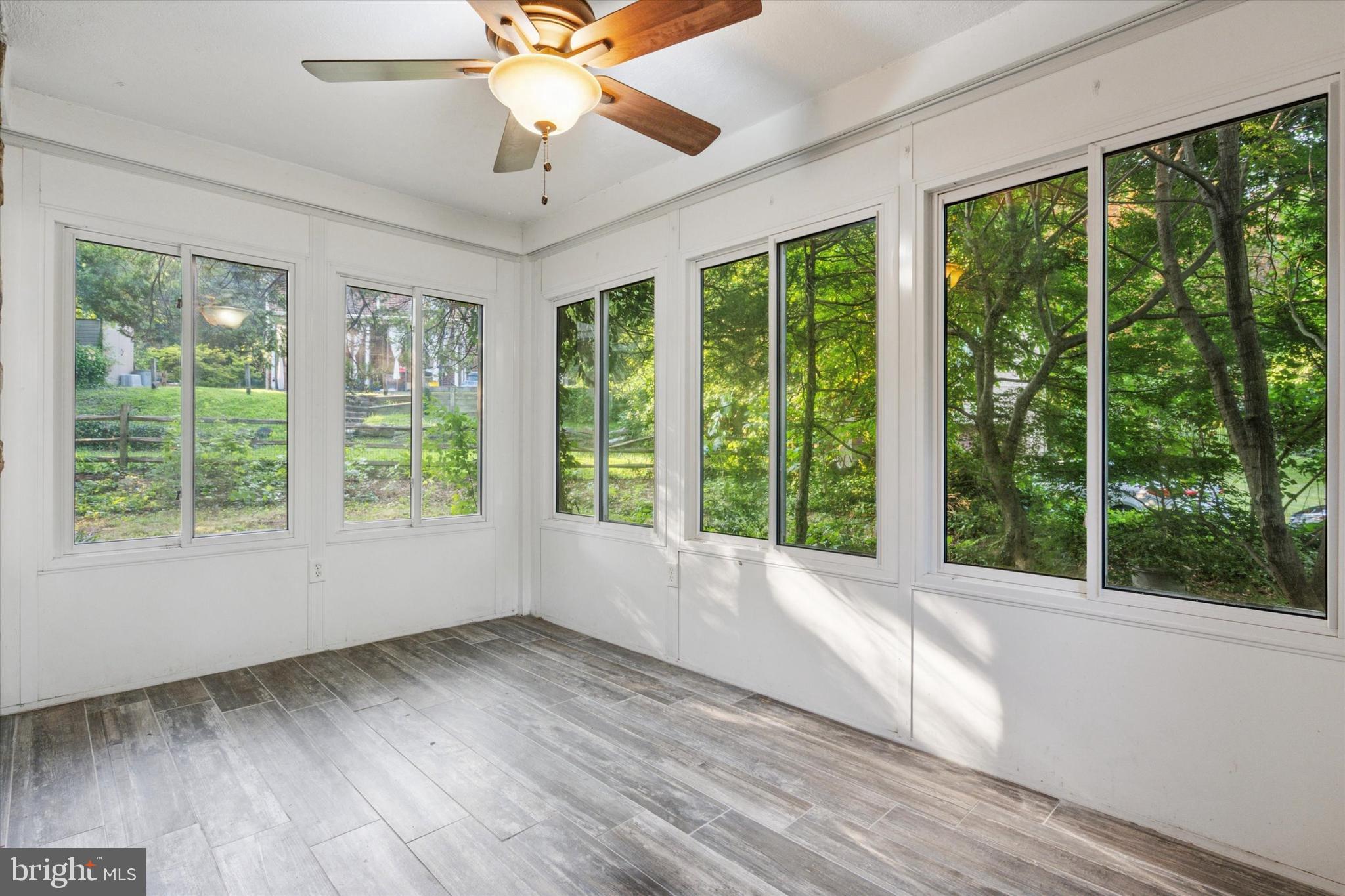 504 Plymouth Road Glenside, PA 19038 - Photo 6 of 28 a view of an empty room with wooden floor and a window