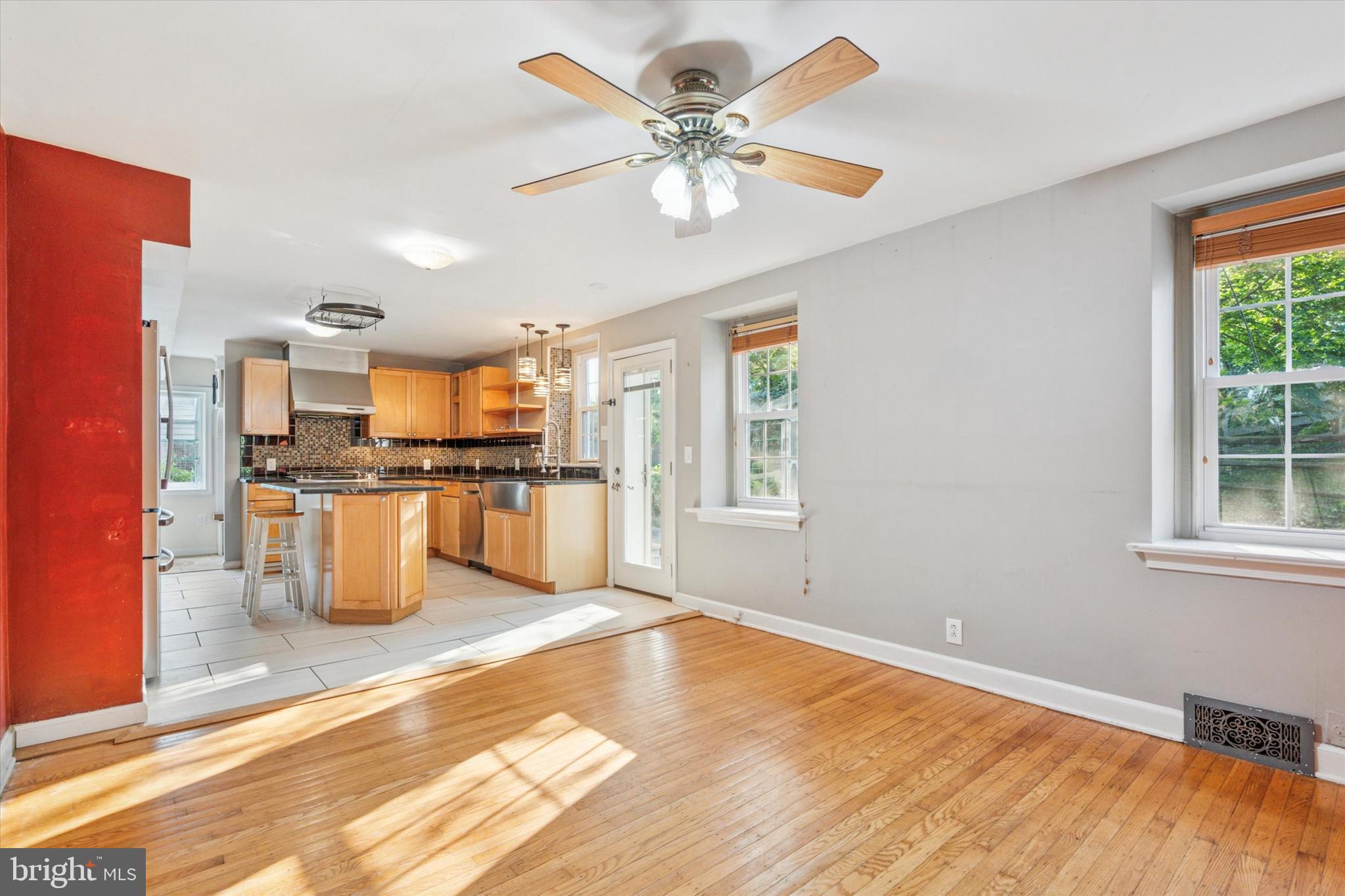 504 Plymouth Road Glenside, PA 19038 - Photo 10 of 28 a kitchen with stainless steel appliances kitchen island granite countertop a refrigerator a stove a sink dishwasher and a dining table with wooden floor
