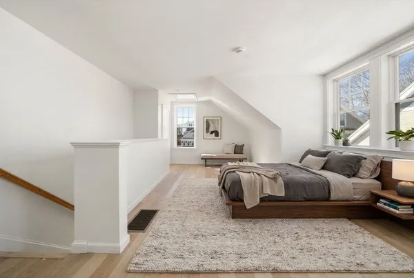 a bedroom with furniture and a rug