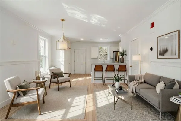 a living room with furniture and a chandelier