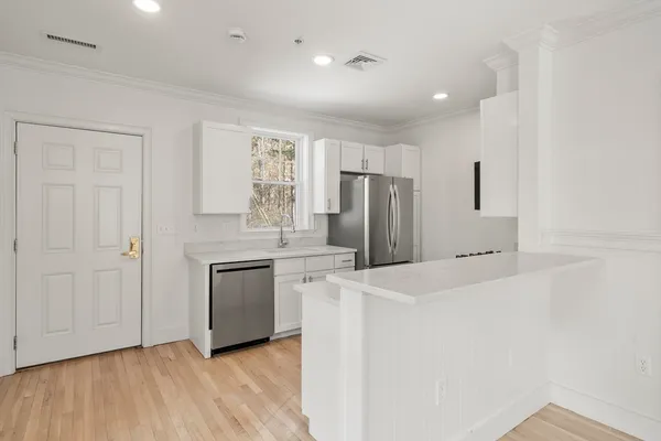 a kitchen with stainless steel appliances a refrigerator and a stove top oven