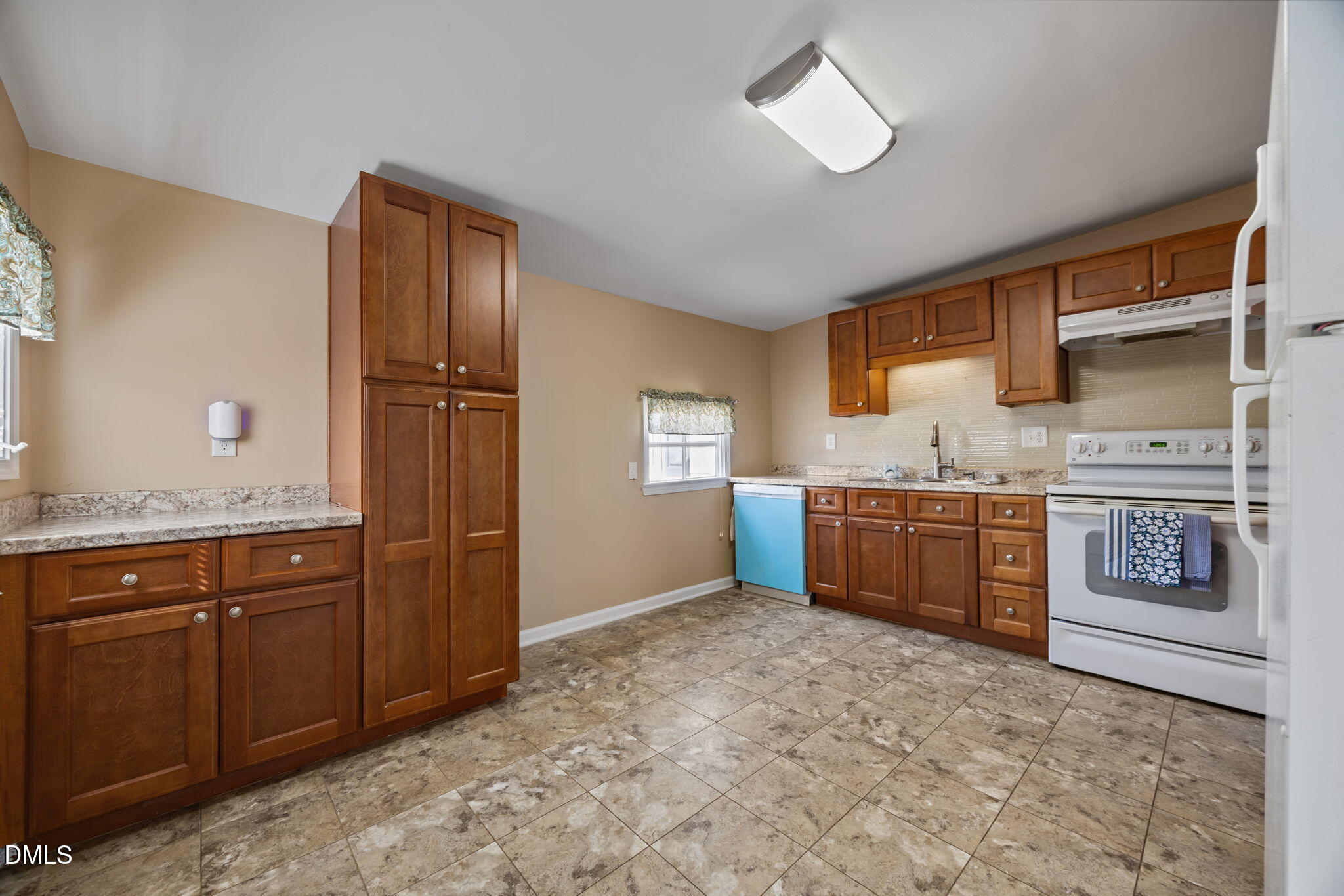 209 Weston Road Garner, NC 27529 - Photo 4 of 37 a kitchen with stainless steel appliances granite countertop a stove a sink and a refrigerator