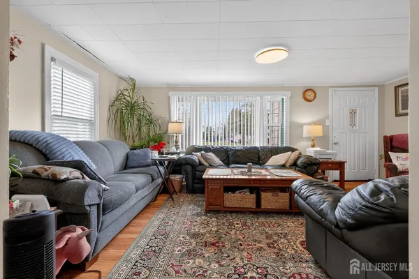 a living room with furniture ceiling fan and a rug