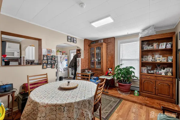a living room with furniture potted plant and kitchen view