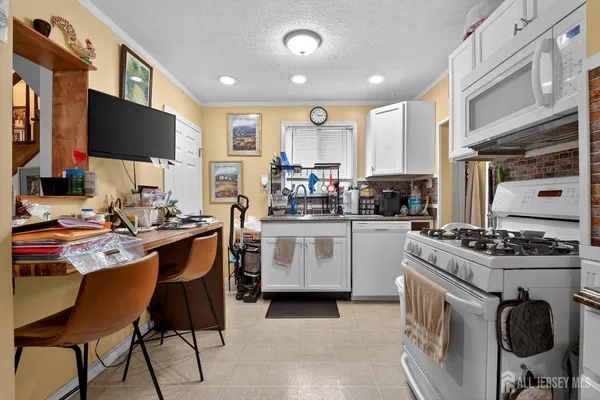 a kitchen with a stove a sink and a refrigerator