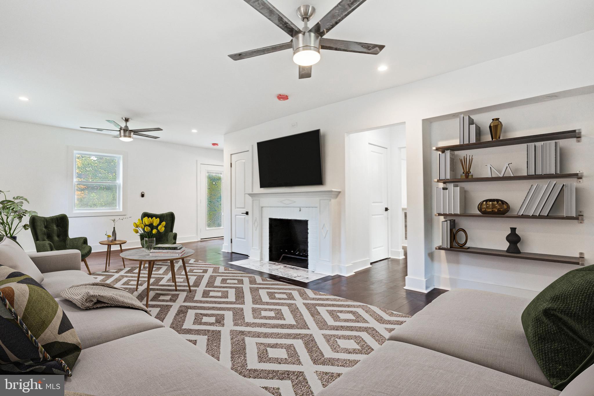 3408 Cheverly Avenue Cheverly, MD 20785 - Photo 2 of 46 a living room with furniture a fireplace and a flat screen tv