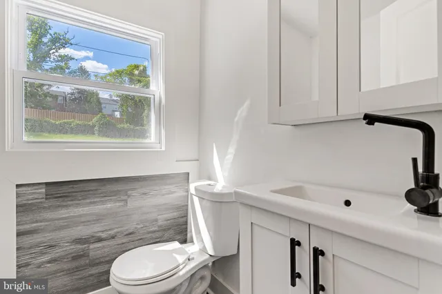 a bathroom with a sink a toilet and tub