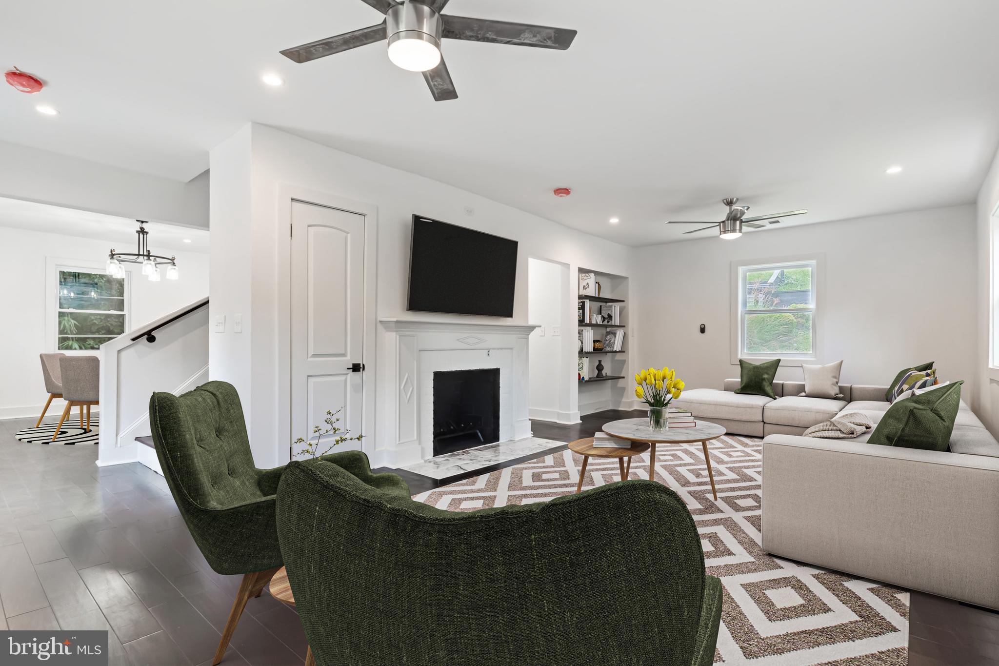 3408 Cheverly Avenue Cheverly, MD 20785 - Photo 27 of 46 a living room with furniture a fireplace and a flat screen tv