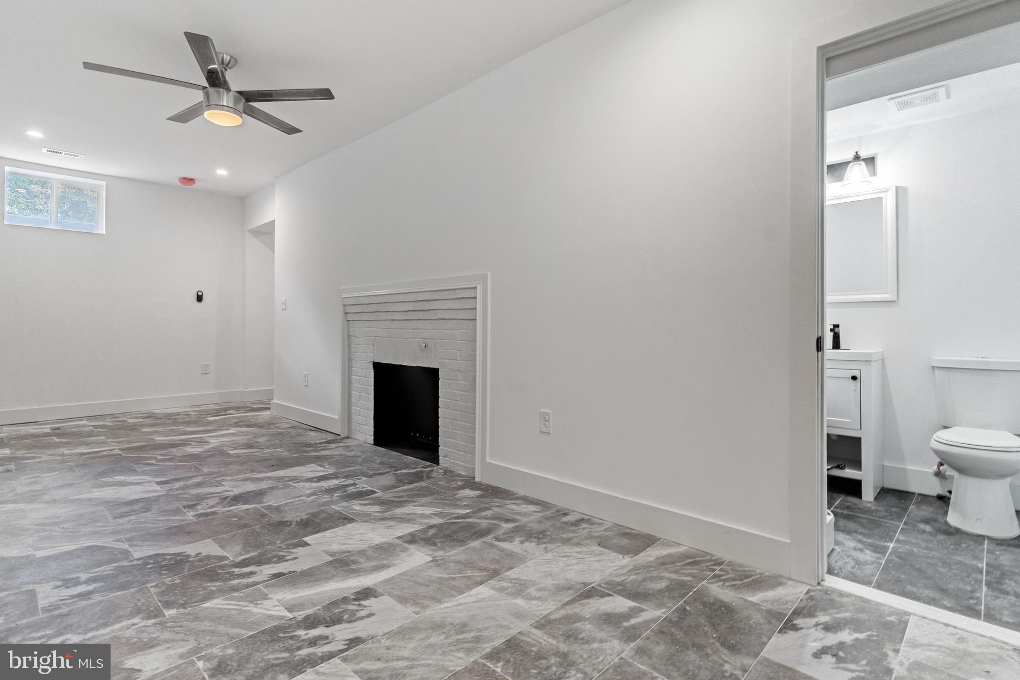 3408 Cheverly Avenue Cheverly, MD 20785 - Photo 30 of 46 a view of a livingroom with a fireplace and a chandelier fan