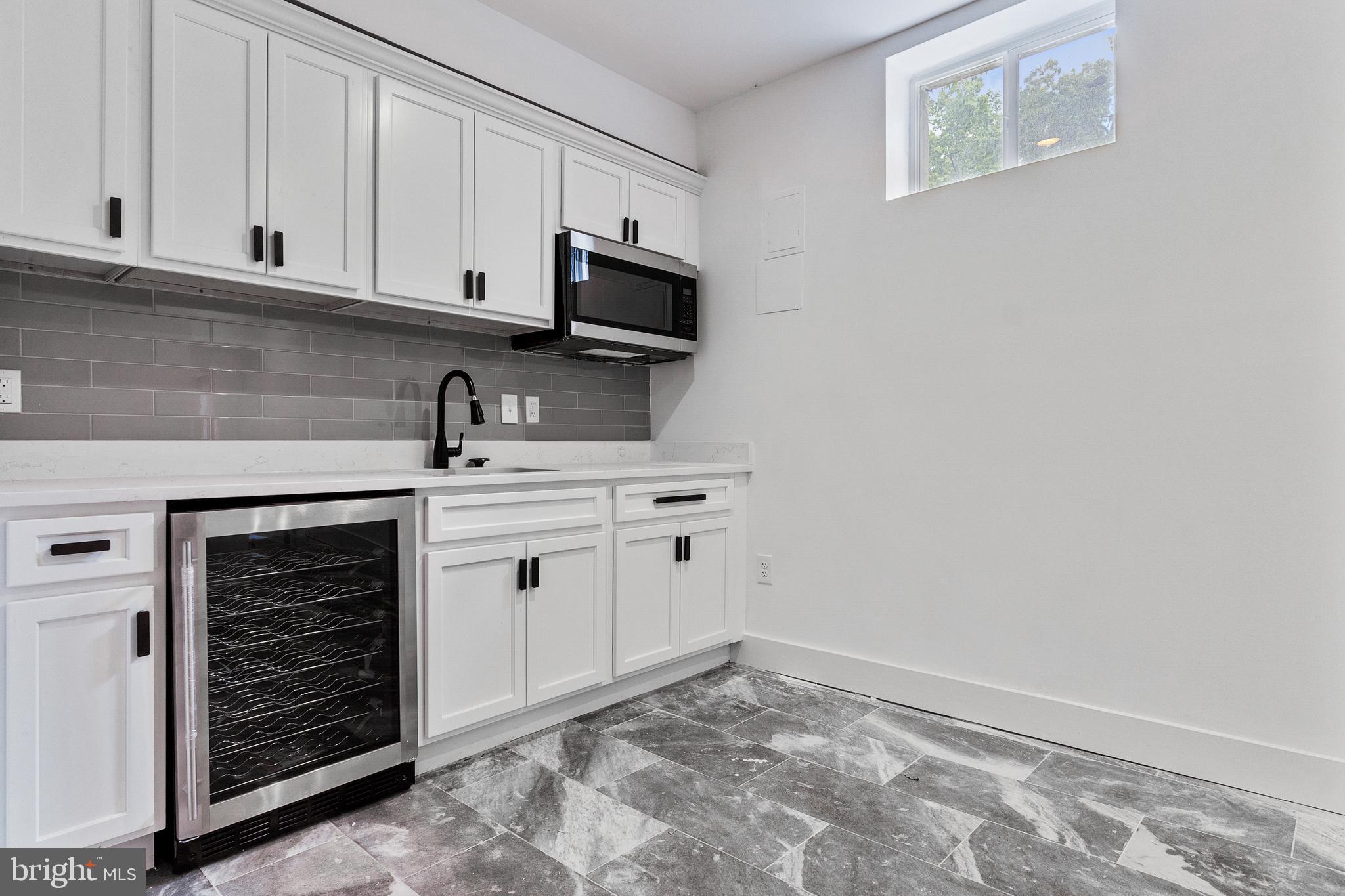 3408 Cheverly Avenue Cheverly, MD 20785 - Photo 34 of 46 a kitchen with white cabinets and white appliances