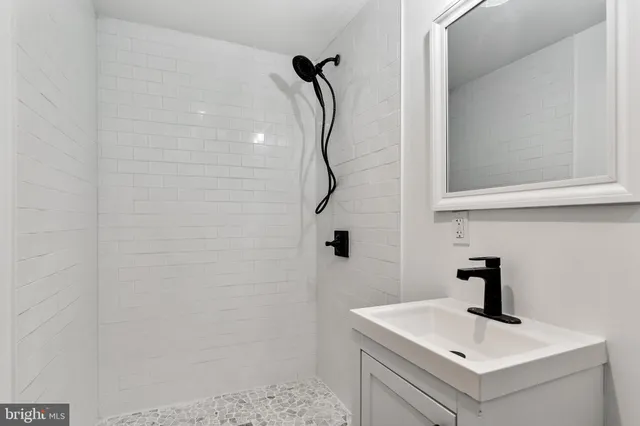 a bathroom with a sink vanity and a mirror