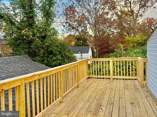a view of balcony with wooden floor and fence