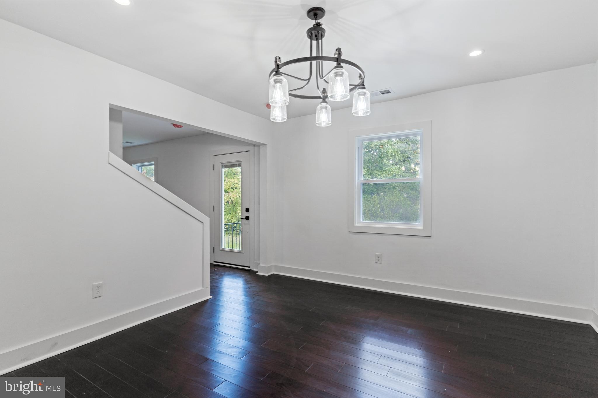3408 Cheverly Avenue Cheverly, MD 20785 - Photo 5 of 46 an empty room with wooden floor chandelier and window