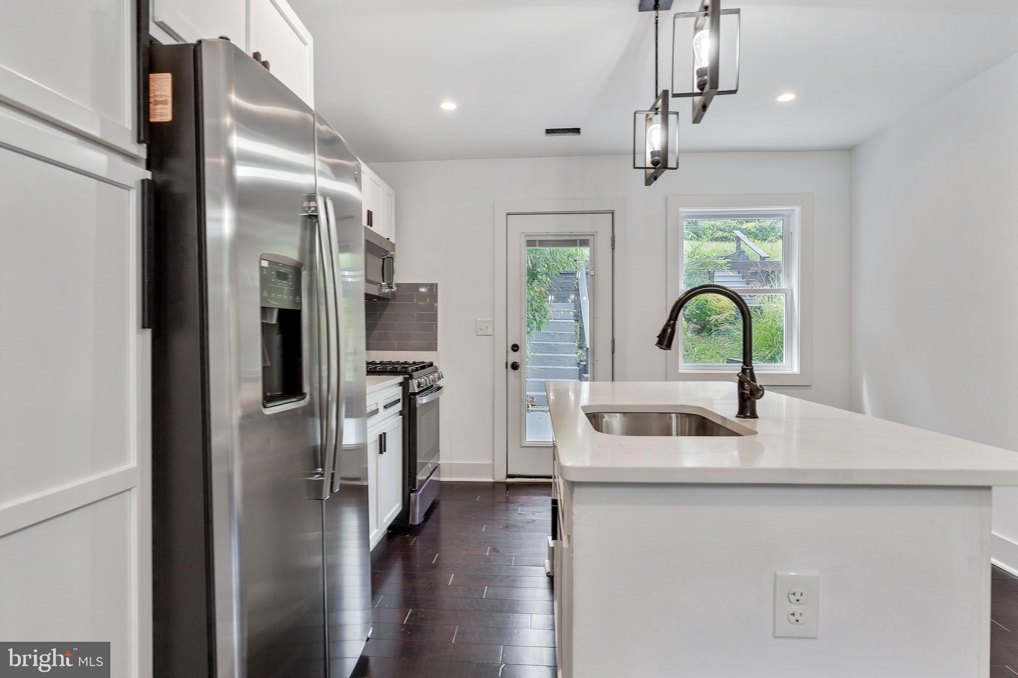 3408 Cheverly Avenue Cheverly, MD 20785 - Photo 8 of 46 a kitchen with a refrigerator and a sink