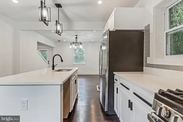 a kitchen with stainless steel appliances a refrigerator and a stove