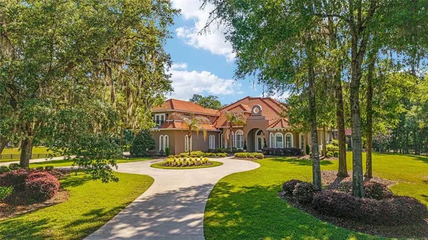 a view of a house with swimming pool and yard