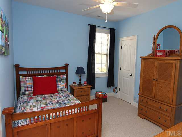 12924 Edsel Drive Raleigh, NC 27613 - Photo 18 of 25 4th bedroom upstairs with full walk-in closet. Notice that all the bedrooms have lighted ceiling fans. Bedroom