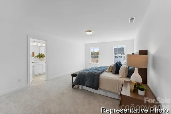 a bedroom with a bed and a night stand