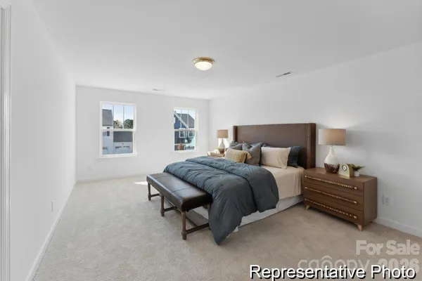 a spacious bedroom with a bed and a window