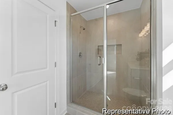 a bathroom with a glass shower door