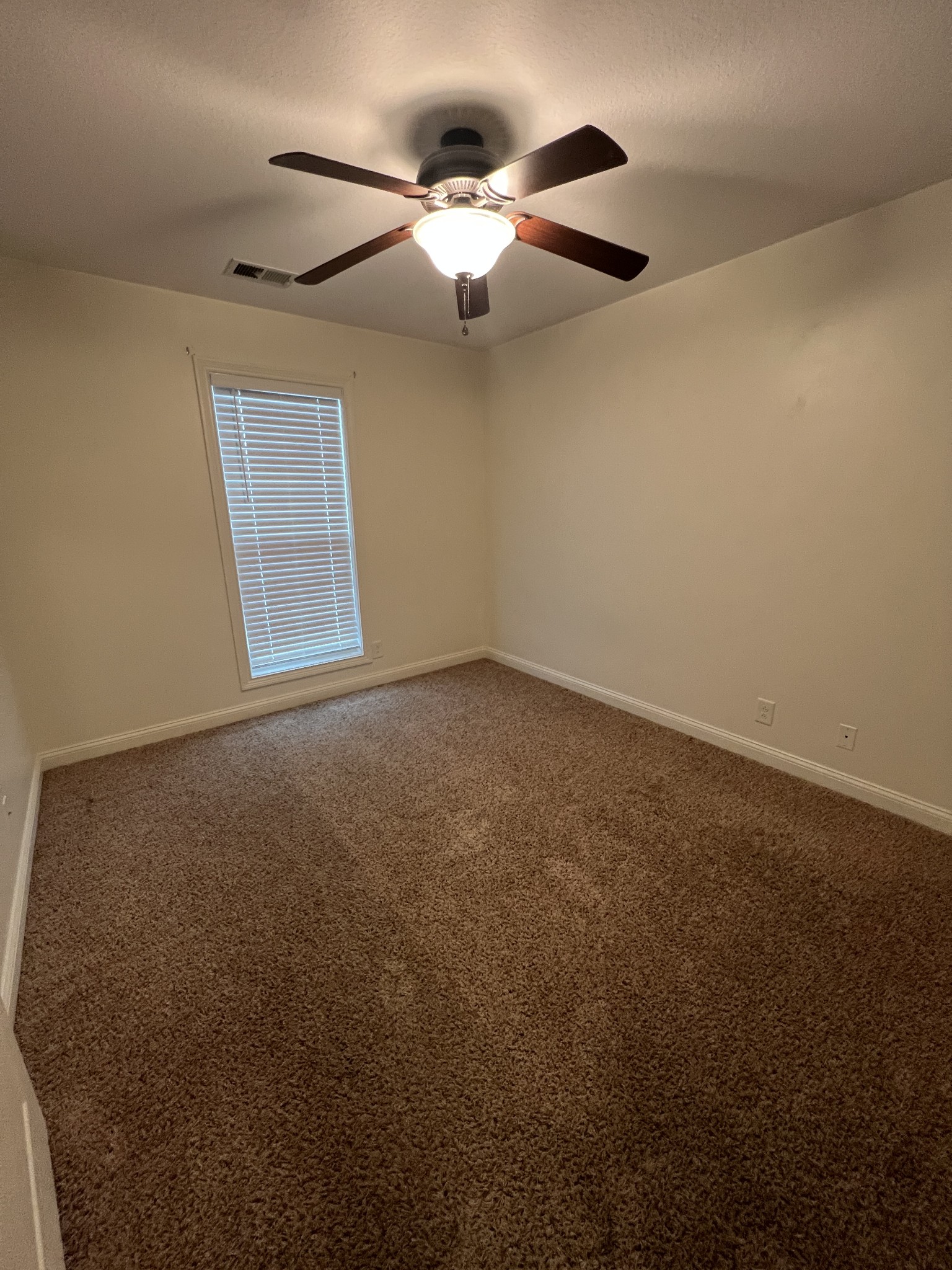 1745 Apache Way Clarksville, TN 37042 - Photo 12 of 28 en empty room with windows and ceiling fan