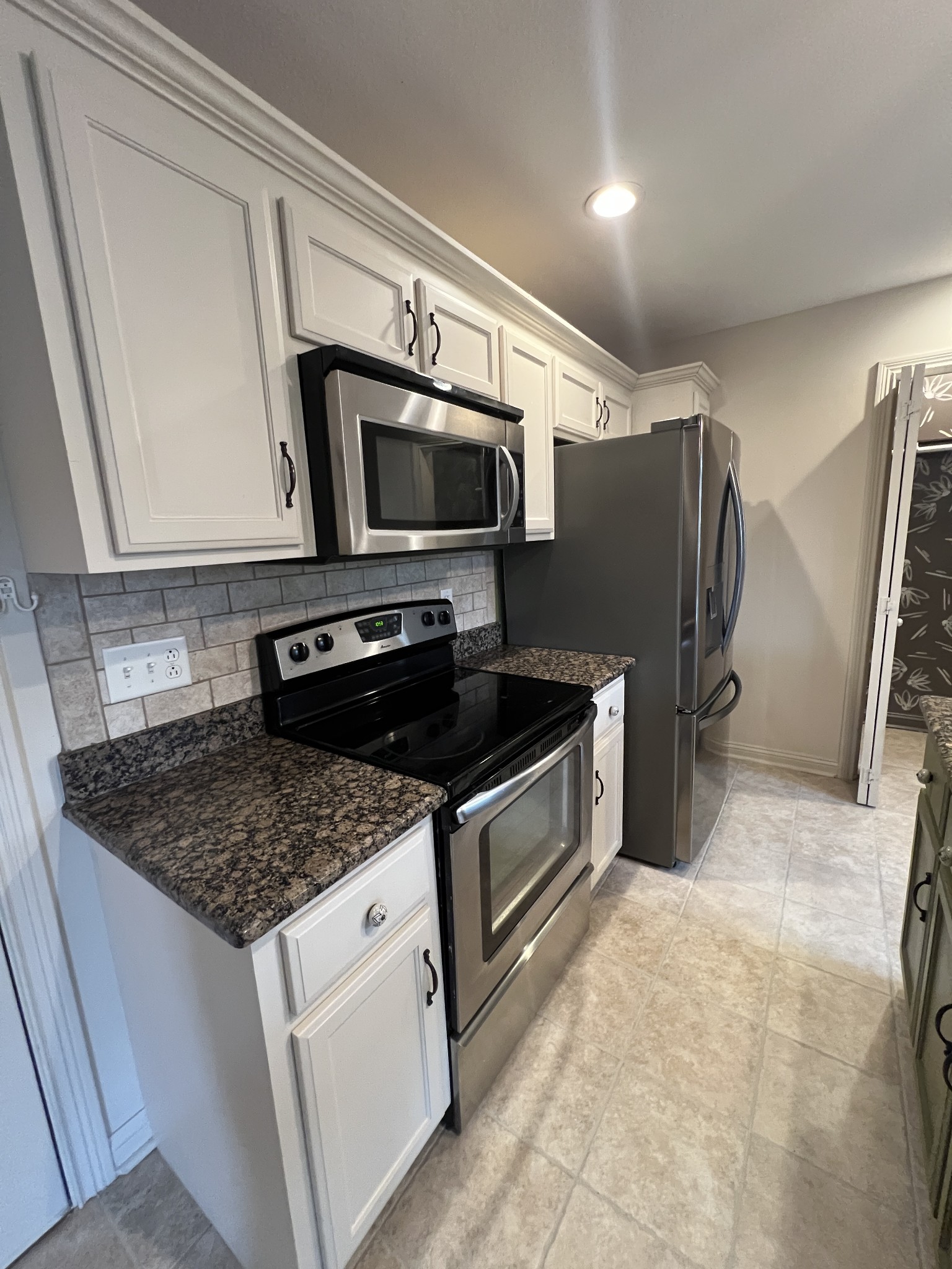 1745 Apache Way Clarksville, TN 37042 - Photo 6 of 28 a kitchen with stainless steel appliances granite countertop a sink stove microwave and refrigerator