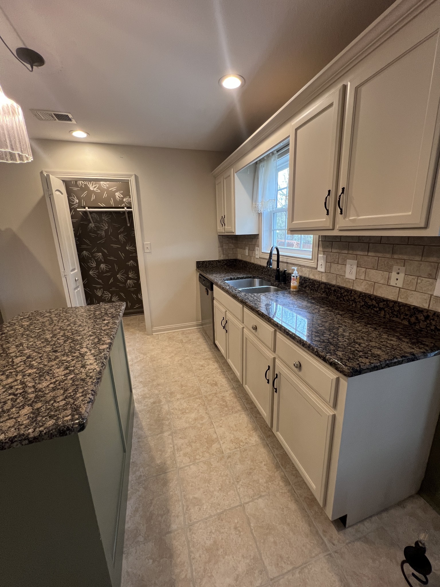 1745 Apache Way Clarksville, TN 37042 - Photo 7 of 28 a kitchen with granite countertop a sink a stove and cabinets