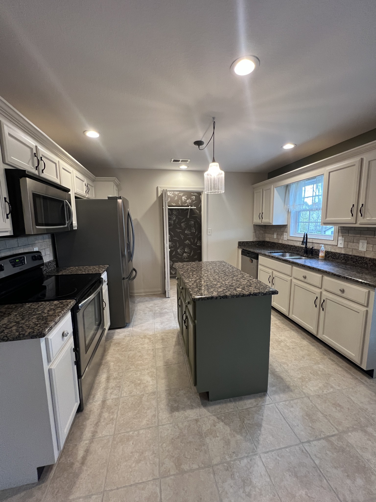 1745 Apache Way Clarksville, TN 37042 - Photo 8 of 28 a large kitchen with stainless steel appliances kitchen island granite countertop a sink and cabinets