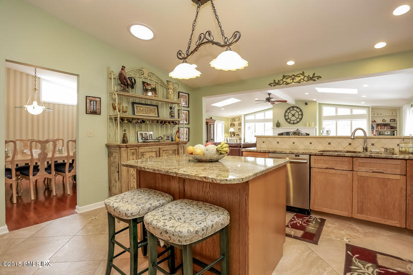105 Florence Road Riverside, CT 06878 - Photo 8 of 30 a kitchen with counter space dining table and chairs
