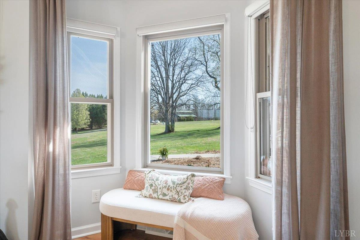 5129 Wheatland Road Bedford, VA 24523 - Photo 12 of 51 a living room with a couch and a floor to ceiling window