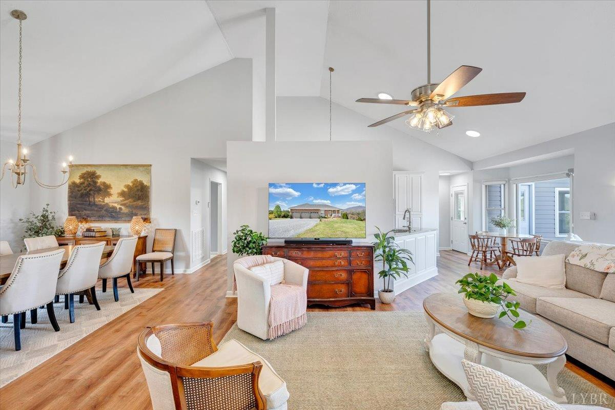 5129 Wheatland Road Bedford, VA 24523 - Photo 13 of 51 a living room with furniture a chandelier and a flat screen tv
