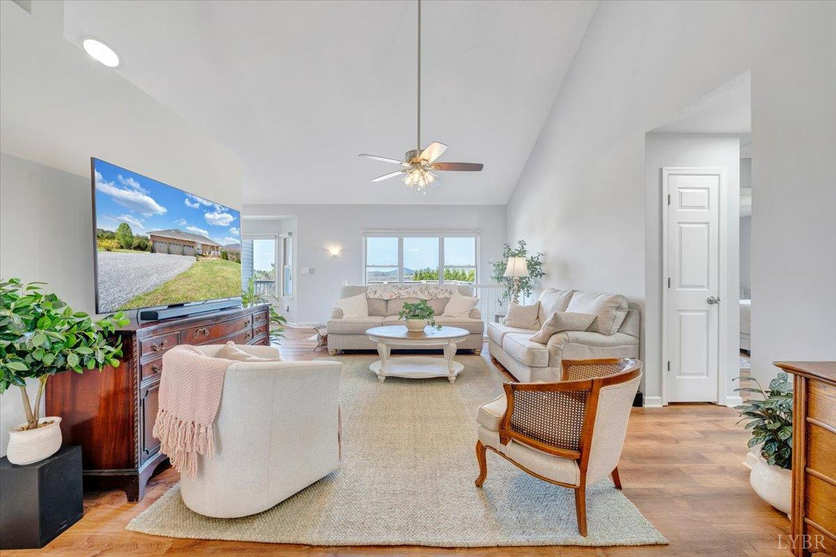5129 Wheatland Road Bedford, VA 24523 - Photo 14 of 51 a living room with furniture and a chandelier