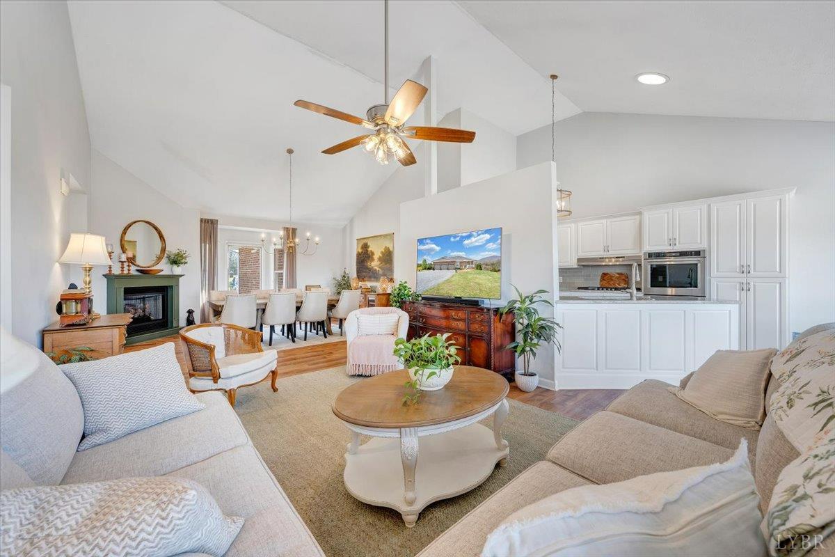 5129 Wheatland Road Bedford, VA 24523 - Photo 15 of 51 a living room with furniture a fireplace and a chandelier