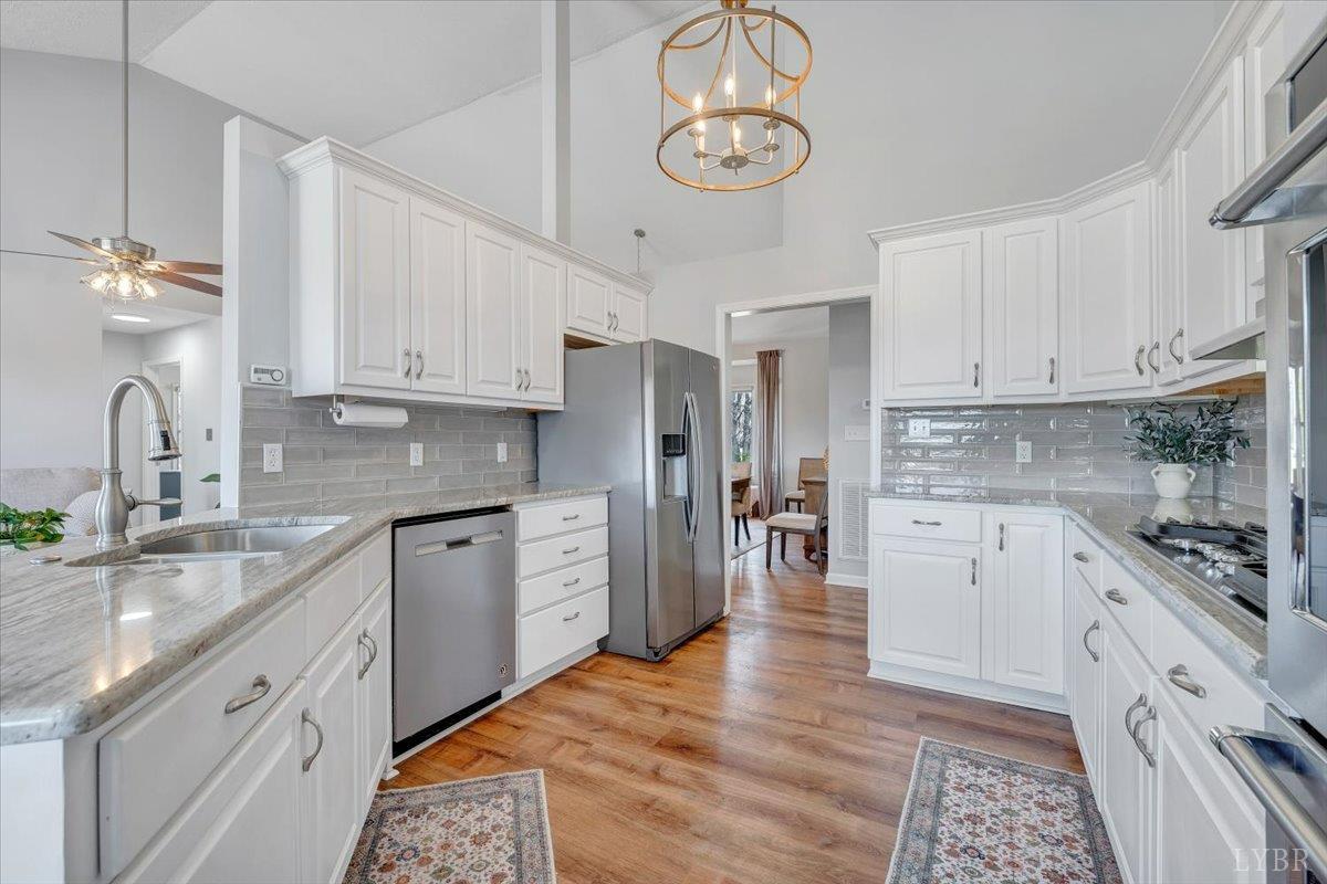 5129 Wheatland Road Bedford, VA 24523 - Photo 18 of 51 a kitchen with stainless steel appliances granite countertop a sink and cabinets