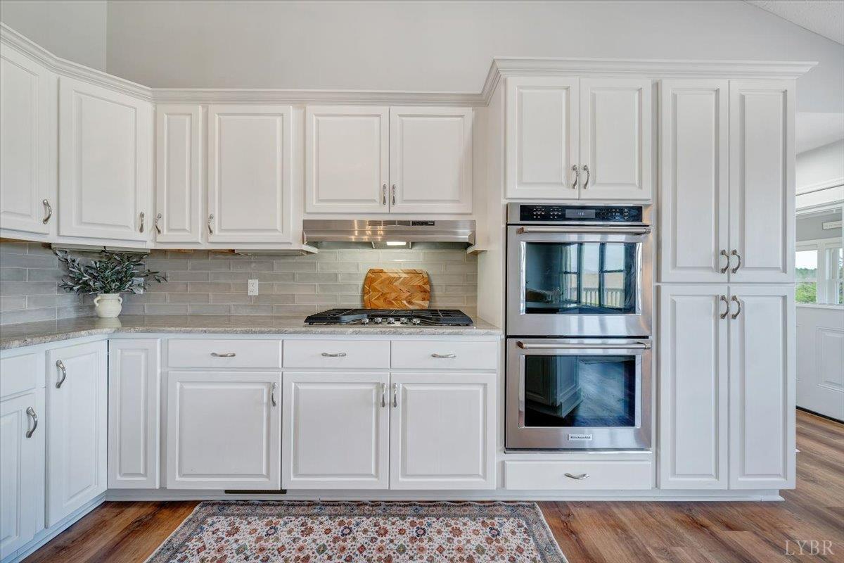 5129 Wheatland Road Bedford, VA 24523 - Photo 20 of 51 a kitchen with white cabinets and appliances