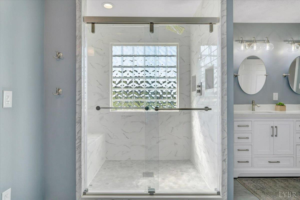 5129 Wheatland Road Bedford, VA 24523 - Photo 27 of 51 a bathroom with a mirror a sink and a window