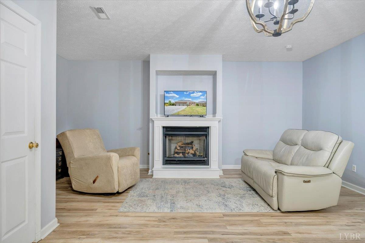 5129 Wheatland Road Bedford, VA 24523 - Photo 35 of 51 a living room with furniture and a fireplace