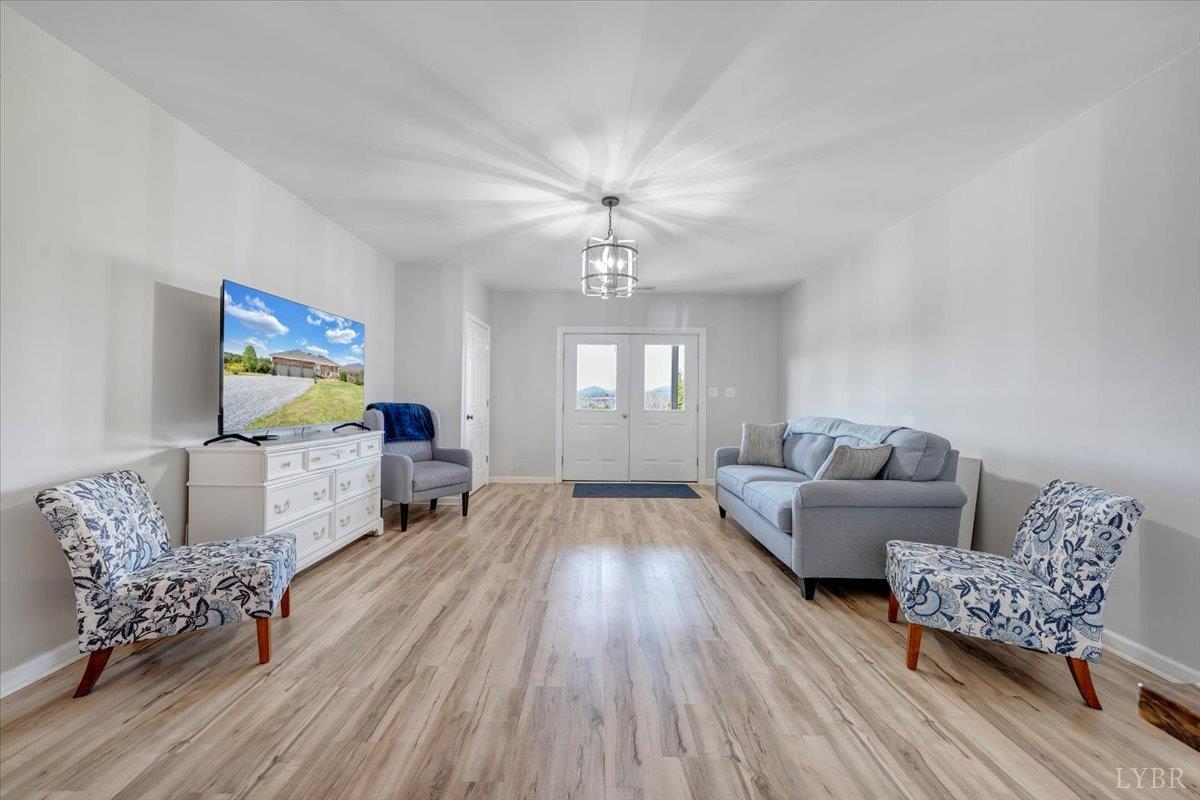 5129 Wheatland Road Bedford, VA 24523 - Photo 37 of 51 a living room with furniture and a chandelier